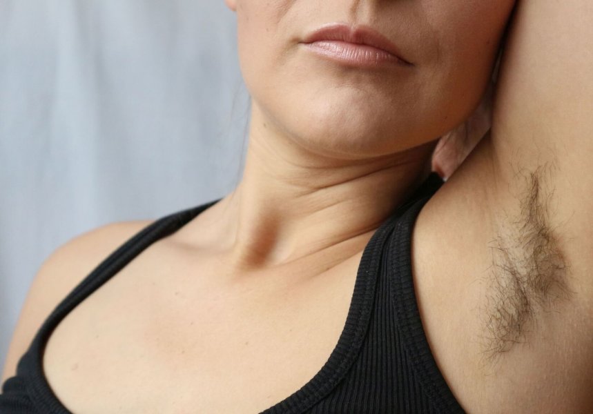 Woman with armpit hair, hair growth, depilation or new natural trend unshaved hair concept.